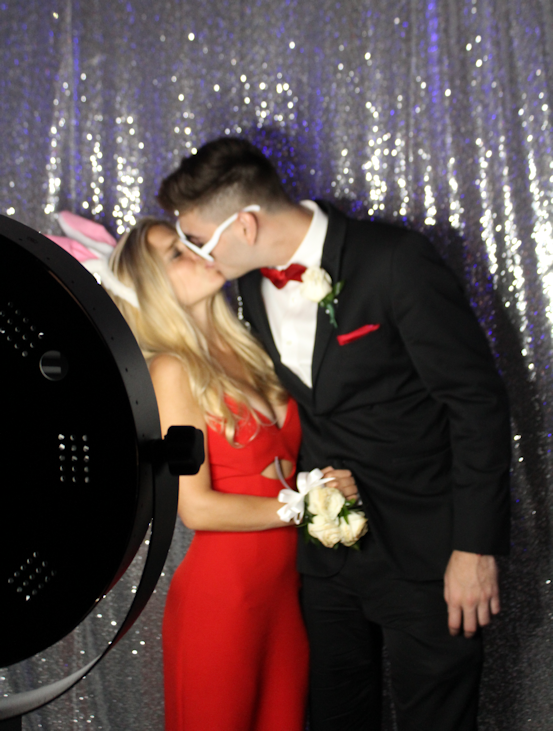 Couple shares a kiss for a boomerang Video on our social media photo booth at an event in Miami Beach, FL